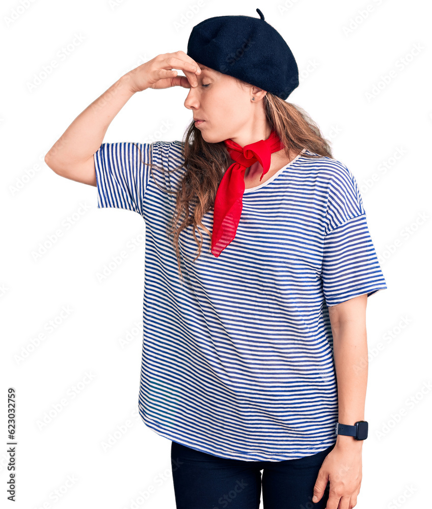 Young beautiful blonde woman wearing french beret and striped t-shirt tired rubbing nose and eyes feeling fatigue and headache. stress and frustration concept. Young beautiful blonde woman wearing french beret and striped t-shirt tired rubbing nose and eyes feeling fatigue and headache. stress and frustration concept.