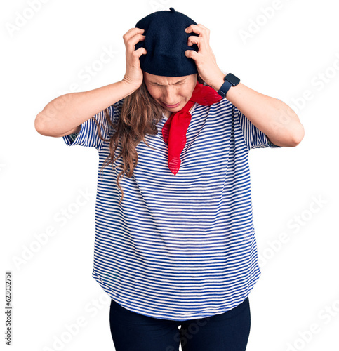 Fotografi Young beautiful blonde woman wearing french beret and striped t-shirt suffering from headache desperate and stressed because pain and migraine