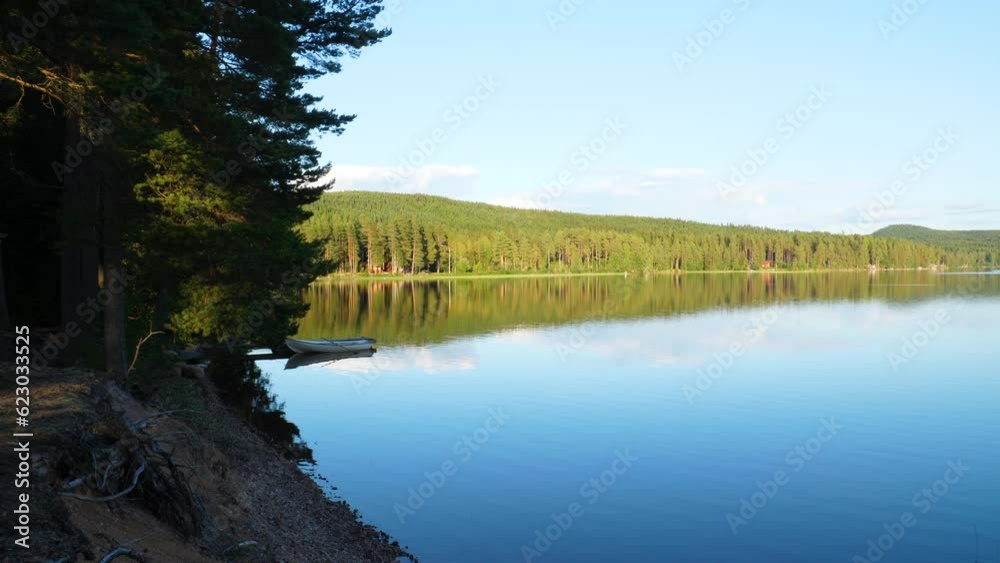 Clip of a small boat attached to a bridge in a secluded lake. Clip of a small boat attached to a bridge in a secluded lake.