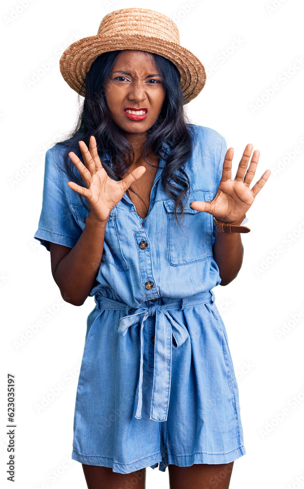 Young indian girl wearing summer hat disgusted expression, displeased and fearful doing disgust face because aversion reaction. Young indian girl wearing summer hat disgusted expression, displeased and fearful doing disgust face because aversion reaction.