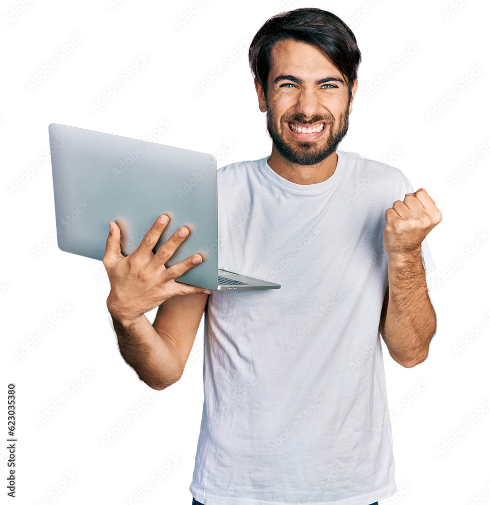 Hispanic man with blue eyes working using computer laptop screaming proud, celebrating victory and success very excited with raised arm Hispanic man with blue eyes working using computer laptop screaming proud, celebrating victory and success very excited with raised arm