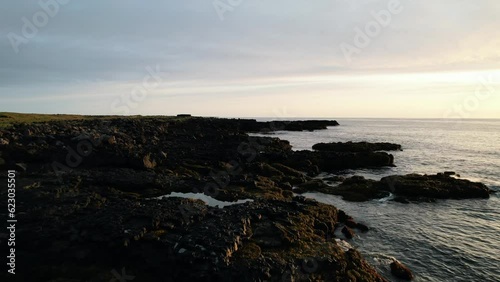 The rocky coast of Iceland at sunset photo