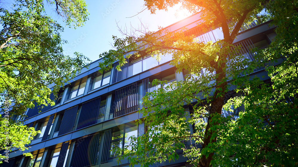 View of Sustainable glass office building with trees for reducing carbon ...