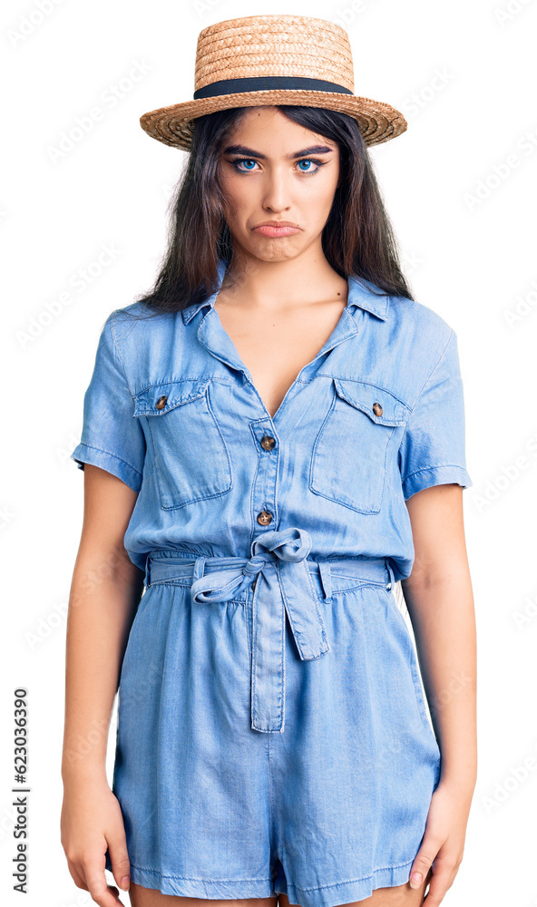 Brunette teenager girl wearing summer hat skeptic and nervous, frowning upset because of problem. negative person. Brunette teenager girl wearing summer hat skeptic and nervous, frowning upset because of problem. negative person.