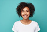 Close up of a young African American woman smiling and wearing a white t-shirt on a turquoise background. Generative AI