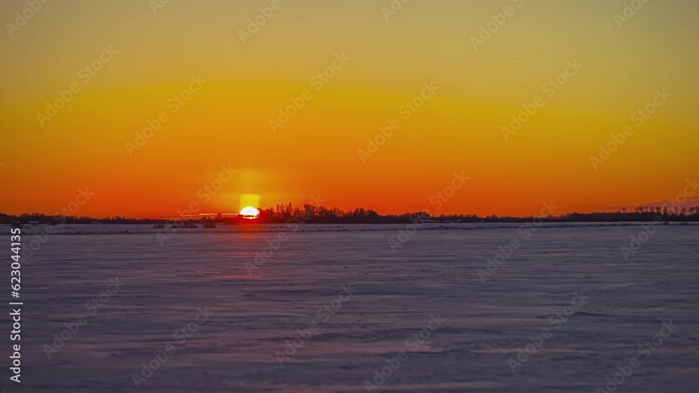 Time lapseOF golden sunrise over the water and an island on the horizon Time lapseOF golden sunrise over the water and an island on the horizon