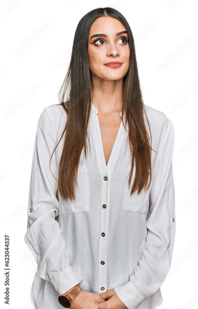Young beautiful woman wearing casual white shirt smiling looking to the side and staring away thinking. Young beautiful woman wearing casual white shirt smiling looking to the side and staring away thinking.