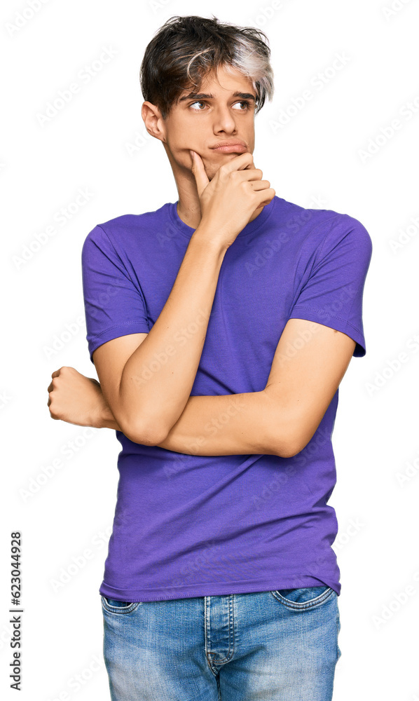 Young hispanic man wearing casual clothes serious face thinking about question with hand on chin, thoughtful about confusing idea Young hispanic man wearing casual clothes serious face thinking about question with hand on chin, thoughtful about confusing idea
