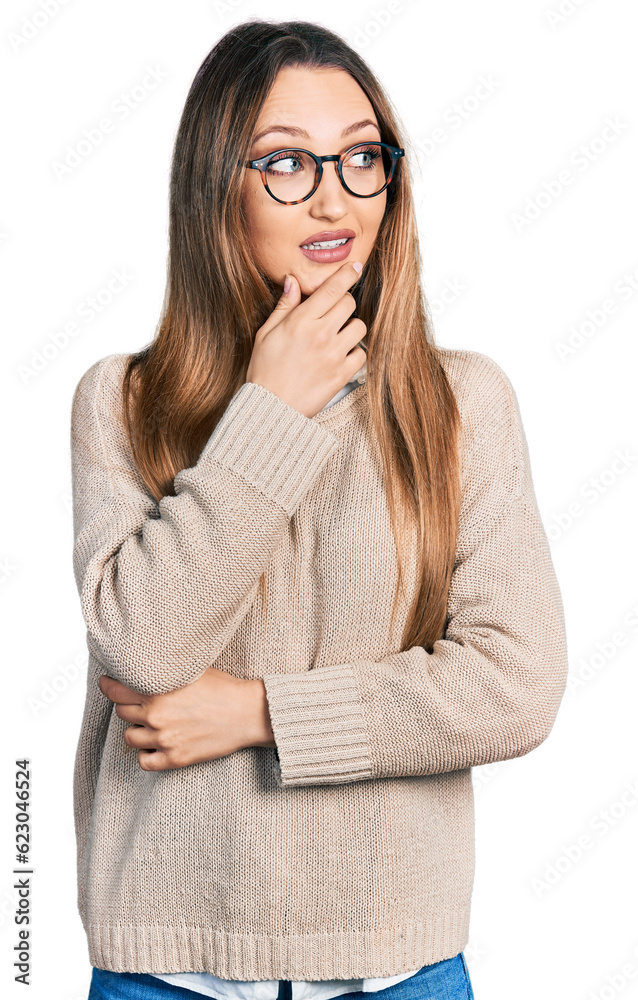 Beautiful caucasian woman wearing casual sweater and glasses with hand on chin thinking about question, pensive expression. smiling with thoughtful face. doubt concept.
