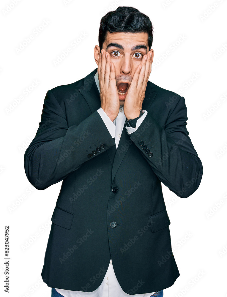 Handsome hispanic man wearing business clothes afraid and shocked, surprise and amazed expression with hands on face Handsome hispanic man wearing business clothes afraid and shocked, surprise and amazed expression with hands on face