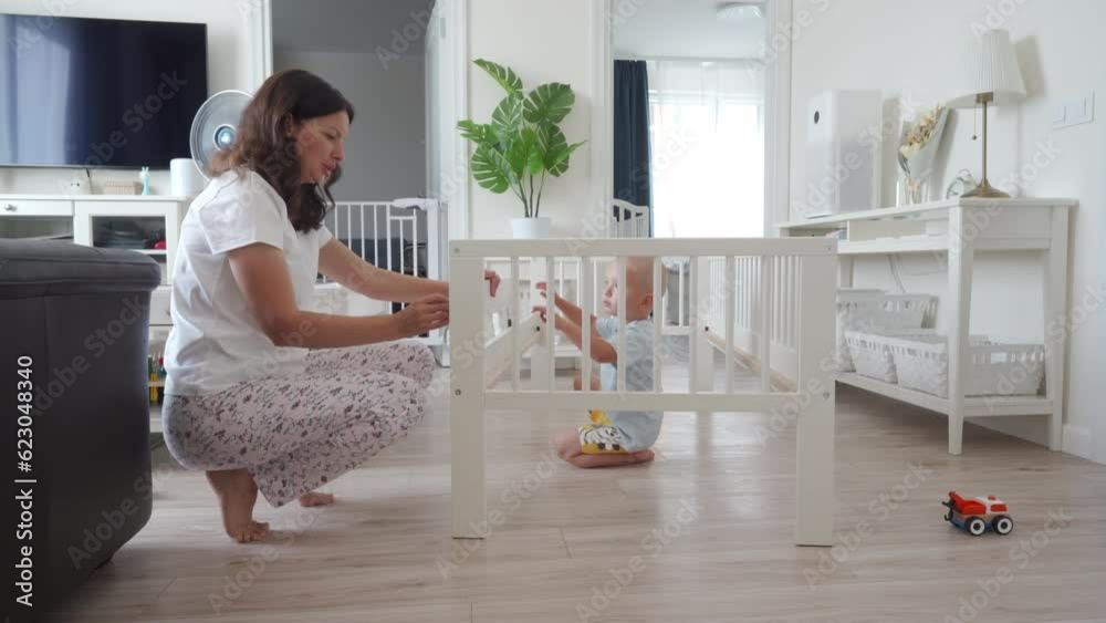 mother and child assembling new children bed for grown up baby mother and child assembling new children bed for grown up baby