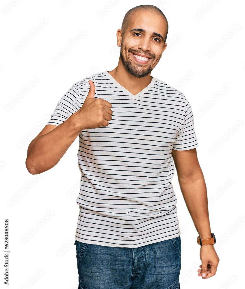 Hispanic adult man wearing casual clothes doing happy thumbs up gesture with hand. approving expression looking at the camera showing success. Hispanic adult man wearing casual clothes doing happy thumbs up gesture with hand. approving expression looking at the camera showing success.