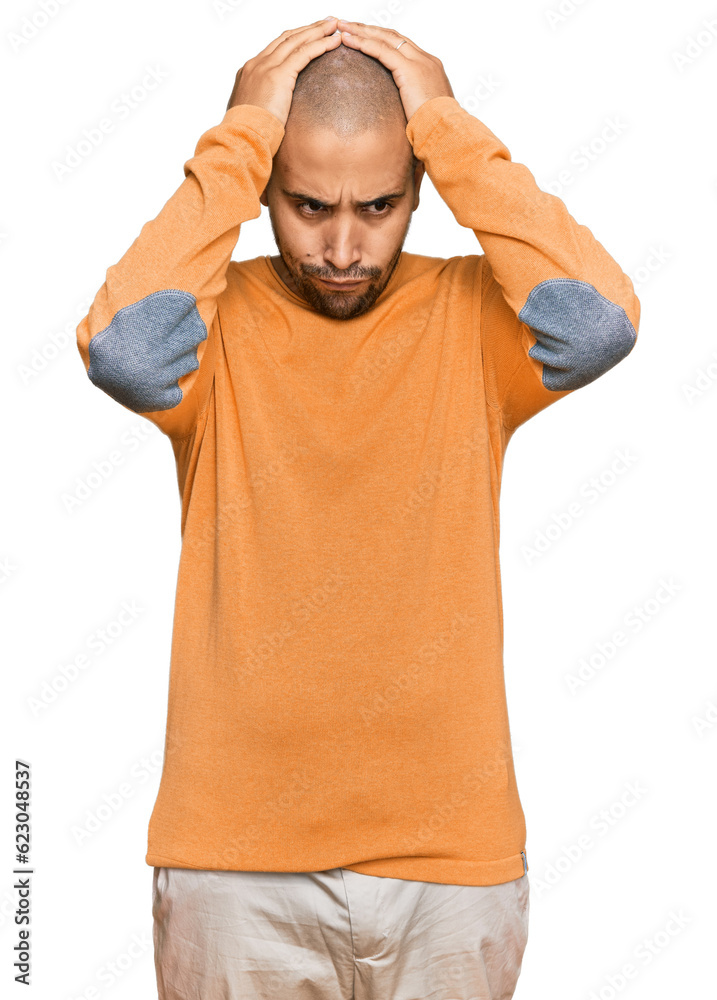 Fototapeta premium Hispanic adult man wearing casual winter sweater suffering from headache desperate and stressed because pain and migraine. hands on head.