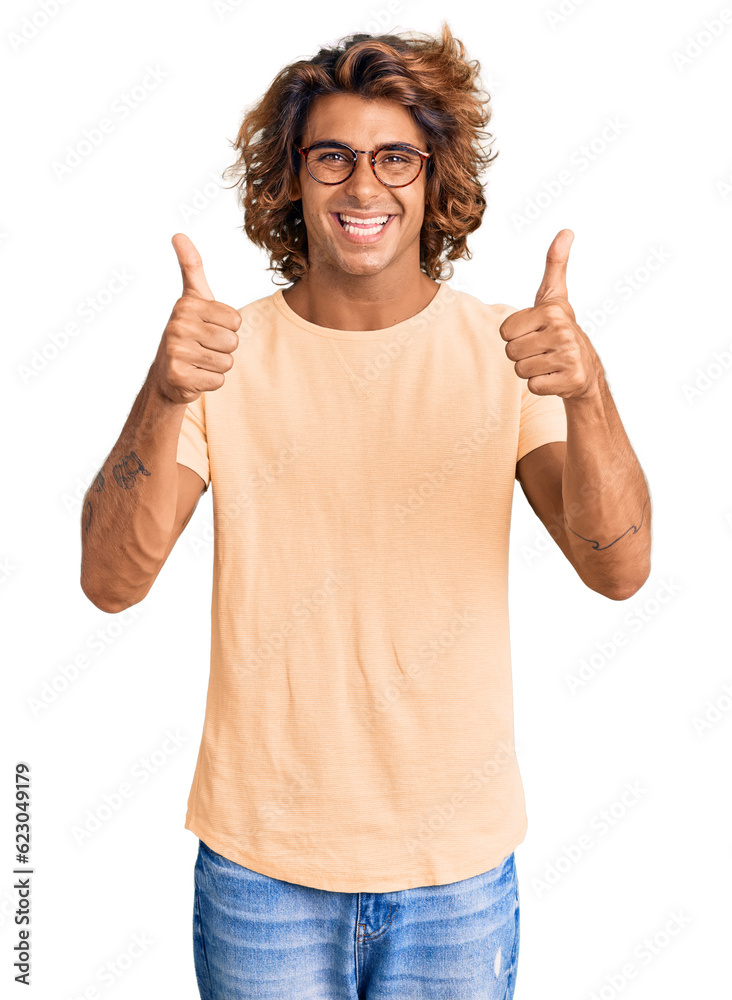 Young hispanic man wearing casual clothes and glasses success sign doing positive gesture with hand, thumbs up smiling and happy. cheerful expression and winner gesture. Young hispanic man wearing casual clothes and glasses success sign doing positive gesture with hand, thumbs up smiling and happy. cheerful expression and winner gesture.