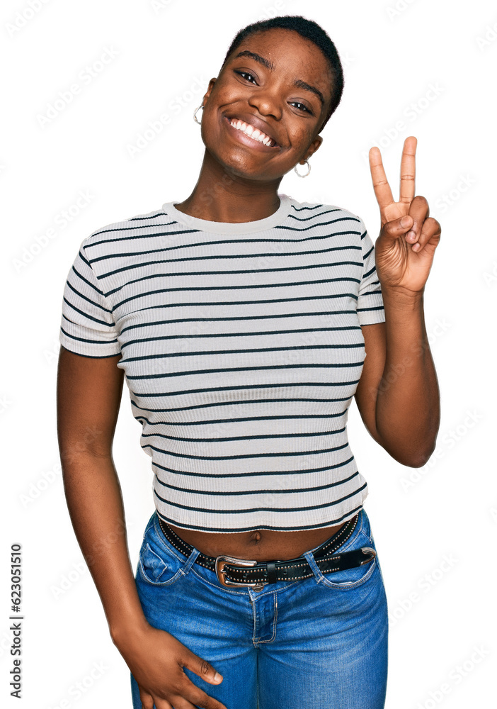 Young african american woman wearing casual clothes smiling with happy face winking at the camera doing victory sign. number two. Young african american woman wearing casual clothes smiling with happy face winking at the camera doing victory sign. number two.