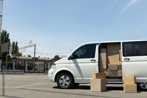 A white delivery service car with boxes inside