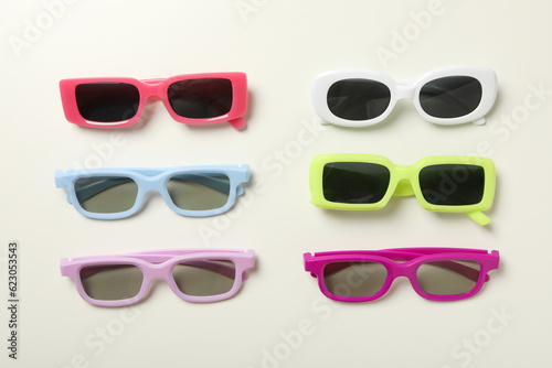 A pile of sunglasses, with on a light background