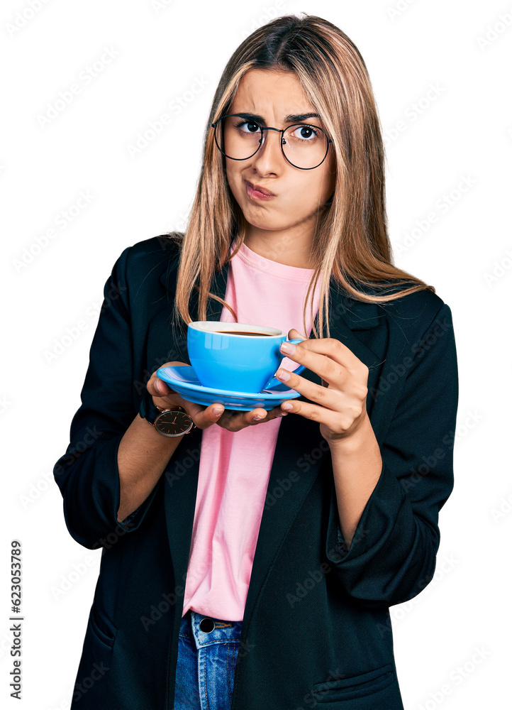 Hispanic young woman drinking a cup of coffee skeptic and nervous, frowning upset because of problem. negative person. Hispanic young woman drinking a cup of coffee skeptic and nervous, frowning upset because of problem. negative person.