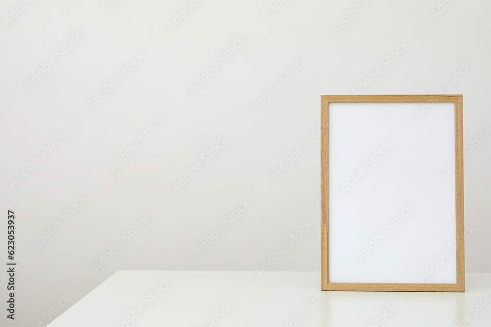 Wooden photo frame on the table on a white background Wooden photo frame on the table on a white background