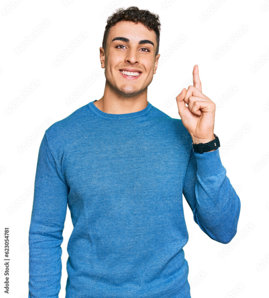 Hispanic young man wearing casual clothes pointing finger up with successful idea. exited and happy. number one.