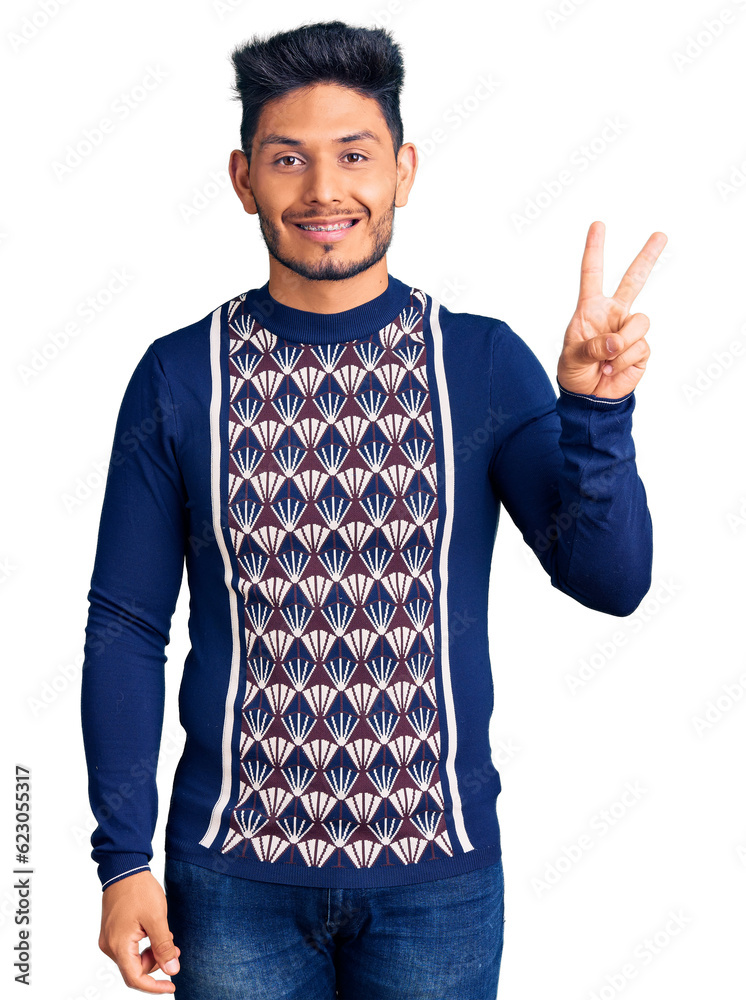 Handsome latin american young man wearing casual winter sweater showing and pointing up with fingers number two while smiling confident and happy. Handsome latin american young man wearing casual winter sweater showing and pointing up with fingers number two while smiling confident and happy.