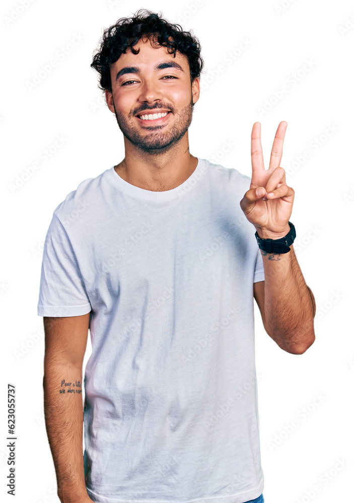 Hispanic young man with beard wearing casual white t shirt showing and pointing up with fingers number two while smiling confident and happy. Hispanic young man with beard wearing casual white t shirt showing and pointing up with fingers number two while smiling confident and happy.