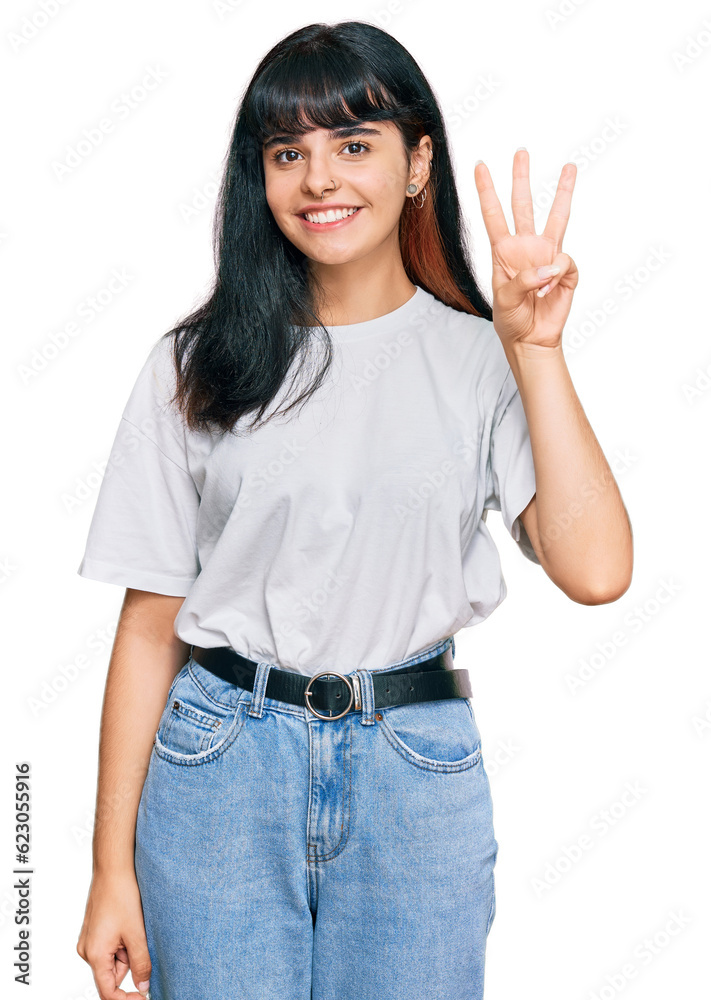 Young hispanic girl wearing casual clothes showing and pointing up with fingers number three while smiling confident and happy. Young hispanic girl wearing casual clothes showing and pointing up with fingers number three while smiling confident and happy.