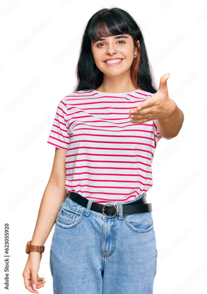 Young hispanic girl wearing casual clothes smiling friendly offering handshake as greeting and welcoming. successful business. Young hispanic girl wearing casual clothes smiling friendly offering handshake as greeting and welcoming. successful business.