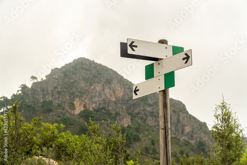  Signpost with arrows indicating various roads and trails © MiguelAngel