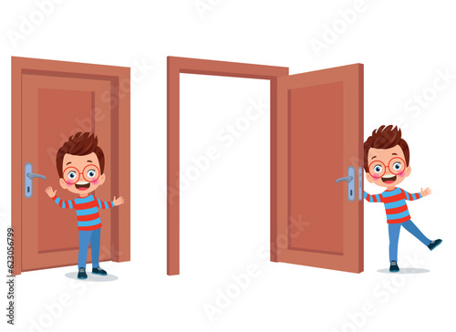 little kid standing and holding door knob