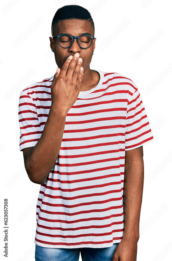 Young african american man wearing casual t shirt and glasses bored yawning tired covering mouth with hand. restless and sleepiness. Young african american man wearing casual t shirt and glasses bored yawning tired covering mouth with hand. restless and sleepiness.