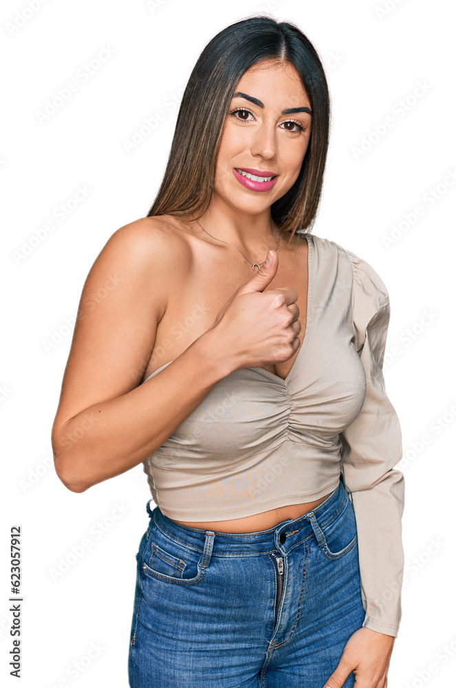 Young hispanic woman wearing casual clothes doing happy thumbs up gesture with hand. approving expression looking at the camera showing success. Young hispanic woman wearing casual clothes doing happy thumbs up gesture with hand. approving expression looking at the camera showing success.