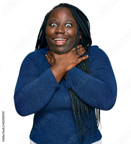 Young black woman with braids wearing casual clothes shouting and suffocate because painful strangle. health problem. asphyxiate and suicide concept.