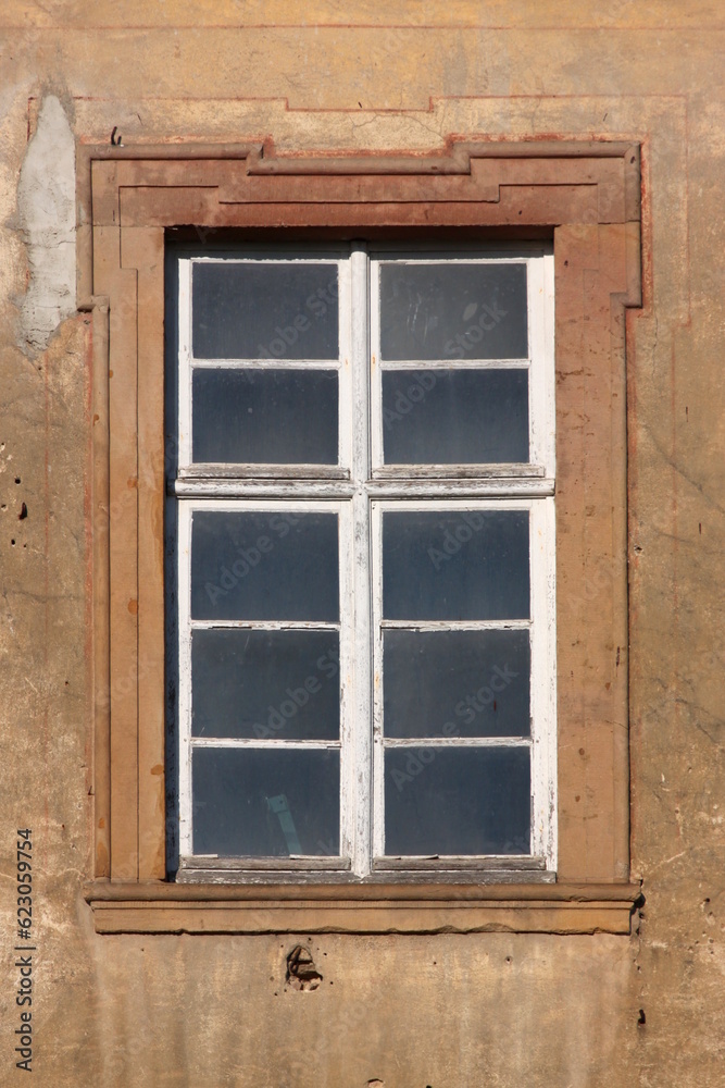 Baroque window with dirty panes and peeling paint on the dilapidated Augustinian monastery facade in Pfaffen-Schwabenheim, Germany