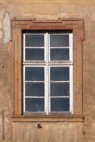 Baroque window with dirty panes and peeling paint on the dilapidated Augustinian monastery facade in Pfaffen-Schwabenheim, Germany