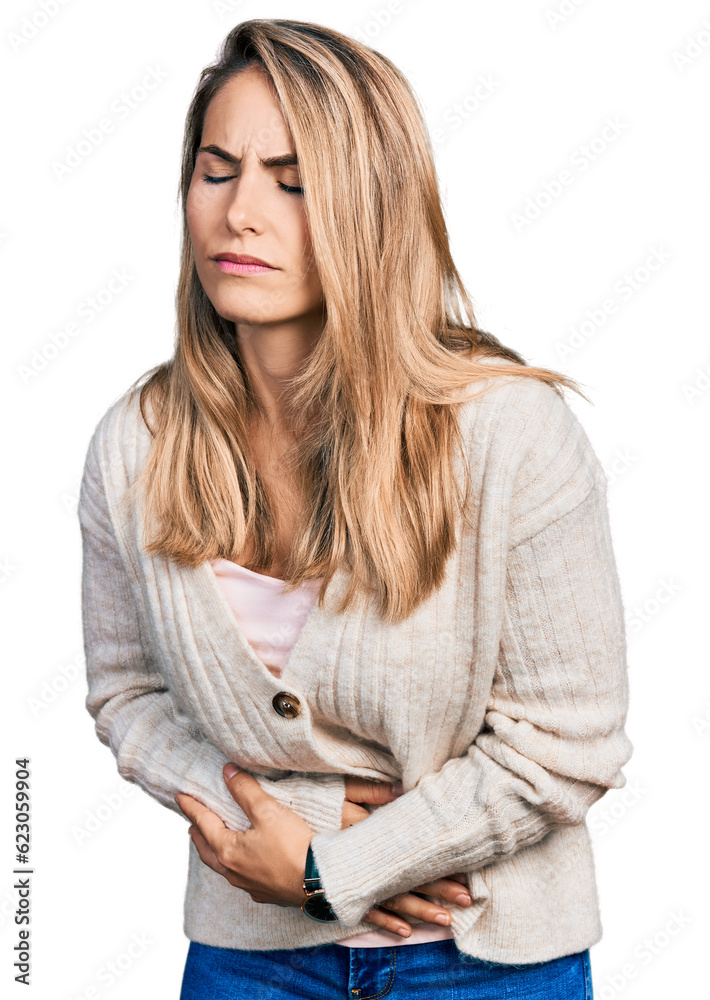 Young blonde woman wearing casual clothes with hand on stomach because indigestion, painful illness feeling unwell. ache concept. Young blonde woman wearing casual clothes with hand on stomach because indigestion, painful illness feeling unwell. ache concept.