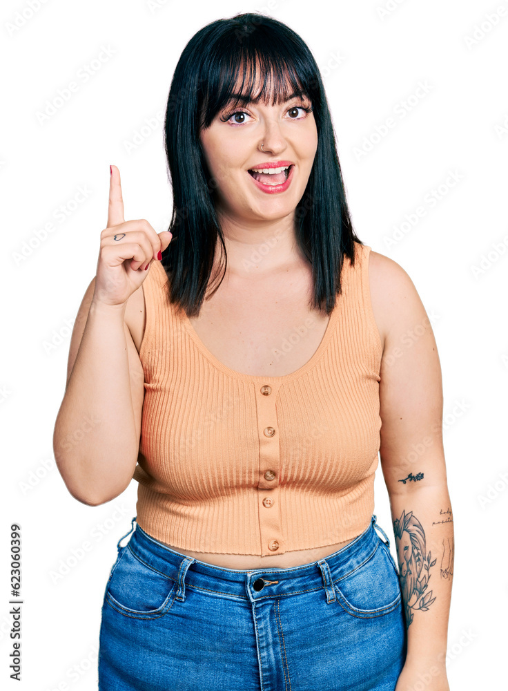Young hispanic plus size woman wearing casual clothes pointing finger up with successful idea. exited and happy. number one. Young hispanic plus size woman wearing casual clothes pointing finger up with successful idea. exited and happy. number one.