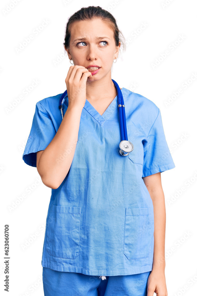 Young beautiful blonde woman wearing doctor uniform and stethoscope looking stressed and nervous with hands on mouth biting nails. anxiety problem.