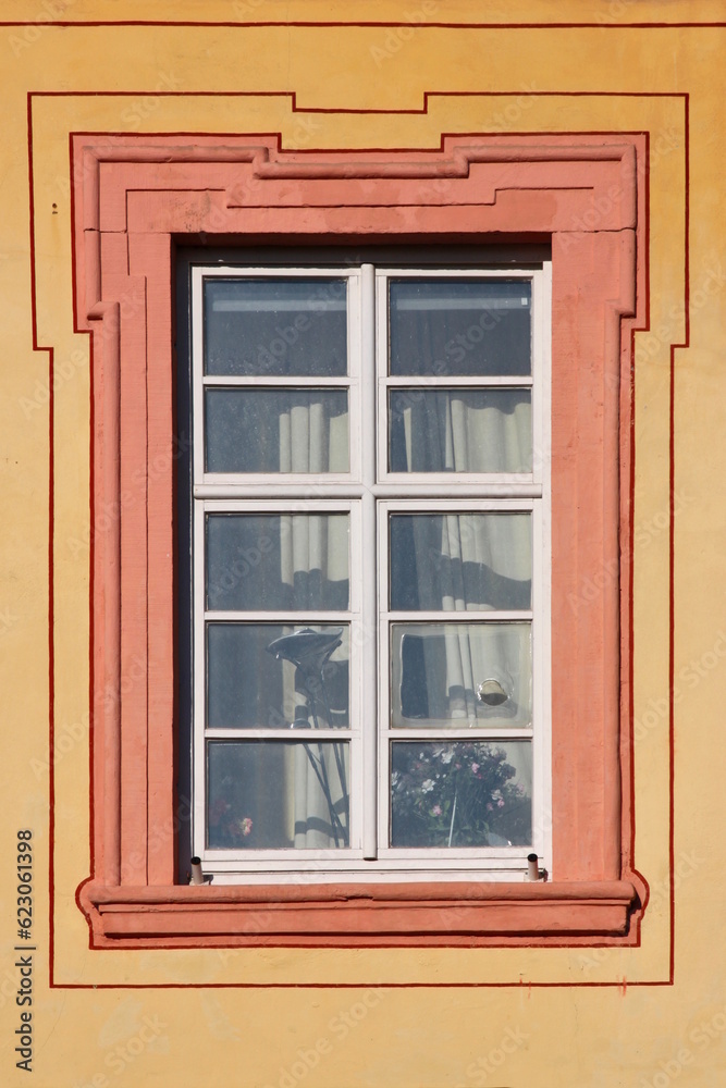Baroque window with dirty broken panes on the Augustinian monastery facade in Pfaffen-Schwabenheim, Germany