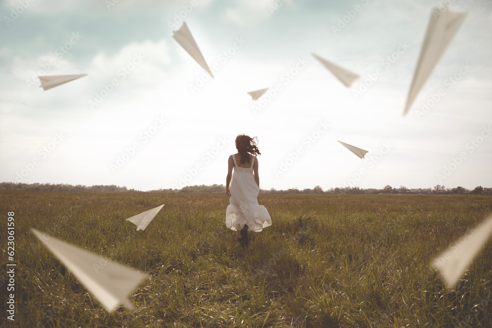 Φωτογραφία surreal flying of paper airplanes surrounding a woman running in the outdoors
