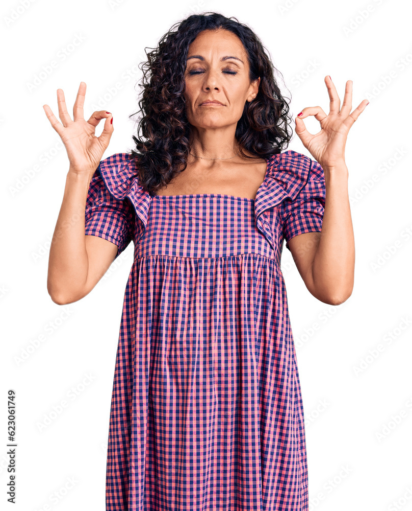 Middle age beautiful woman wearing casual dress relax and smiling with eyes closed doing meditation gesture with fingers. yoga concept. Middle age beautiful woman wearing casual dress relax and smiling with eyes closed doing meditation gesture with fingers. yoga concept.