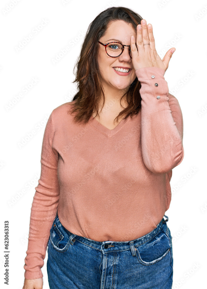 Young plus size woman wearing casual clothes and glasses covering one eye with hand, confident smile on face and surprise emotion. Young plus size woman wearing casual clothes and glasses covering one eye with hand, confident smile on face and surprise emotion.