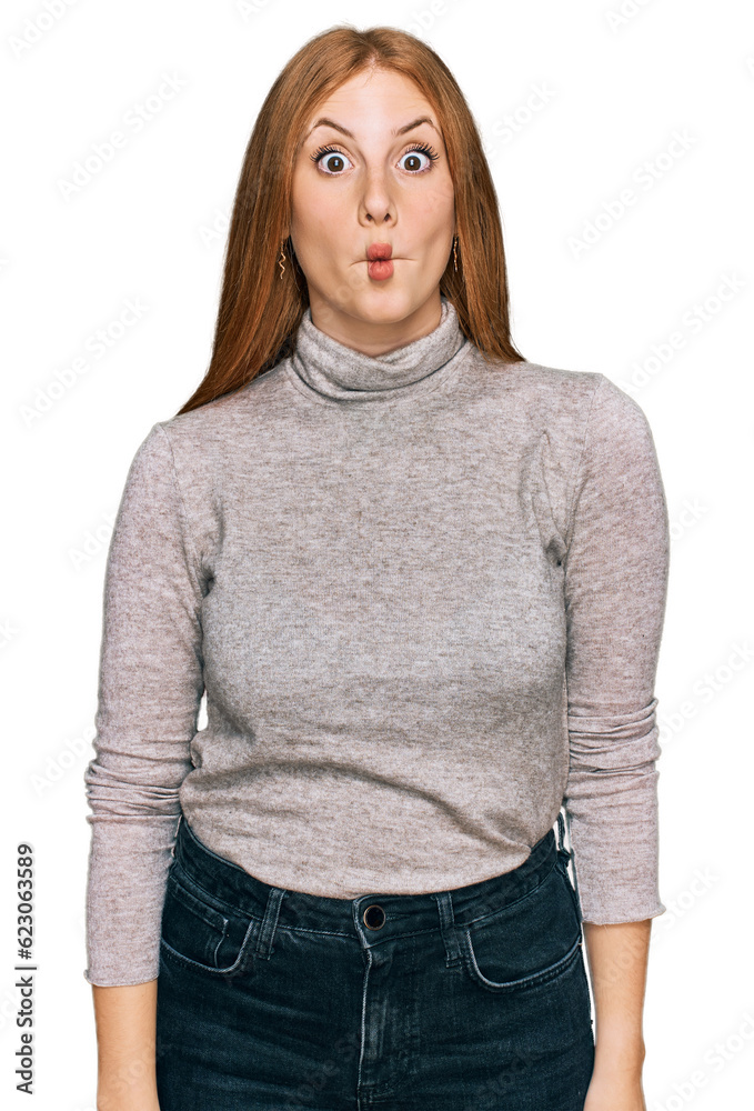 Young irish woman wearing casual clothes making fish face with lips, crazy and comical gesture. funny expression.