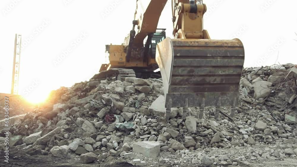 Excavator at construction site dredge sand and material in work action close-up.