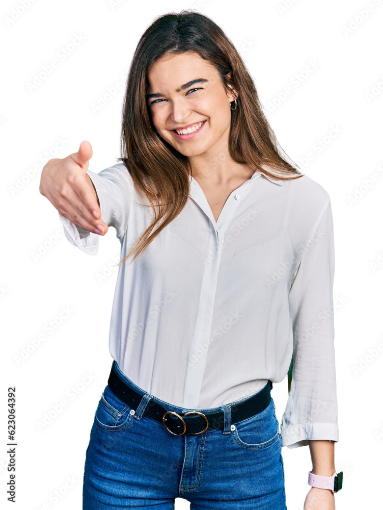 Young caucasian girl wearing casual white shirt smiling friendly offering handshake as greeting and welcoming. successful business. Young caucasian girl wearing casual white shirt smiling friendly offering handshake as greeting and welcoming. successful business.