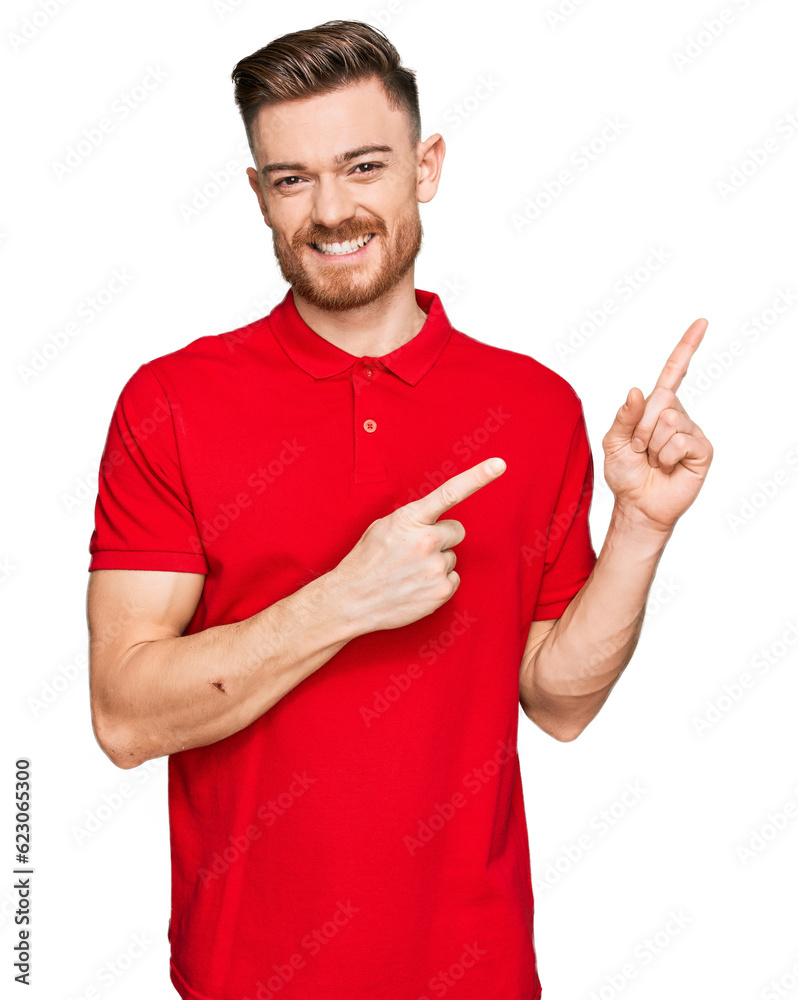 Young redhead man wearing casual clothes smiling and looking at the camera pointing with two hands and fingers to the side. Young redhead man wearing casual clothes smiling and looking at the camera pointing with two hands and fingers to the side.