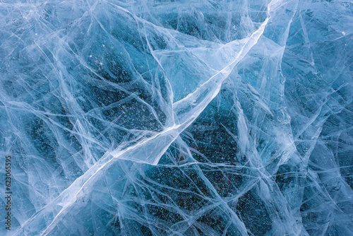 Fototapeta Naklejka Na Ścianę i Meble -  Amazing ice crack texture background, Close-up texture surface cracks of the natural ice in frozen water at Baikal lake, Russia.