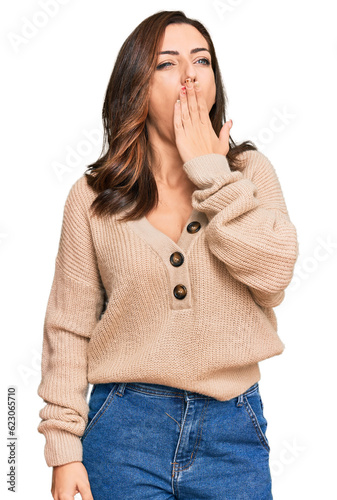Young brunette woman wearing casual winter sweater bored yawning tired covering mouth with hand. restless and sleepiness.