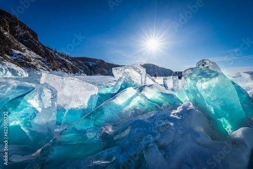 Fototapeta Naklejka Na Ścianę i Meble -  Landscape view of frozen Cape Khoboy - Baikal lake winter with sunset sky background, the most famous tourist attraction in Olkhon island at Baikal lake, Russia