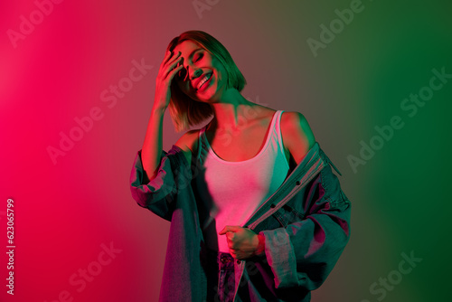 Photo of carefree sweet lady wear denim jacket enjoying party smiling isolated green pink gradient color background